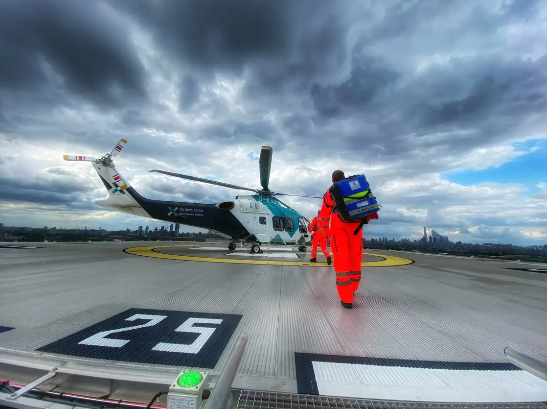 HEMS crew going back to helicopter on helipad