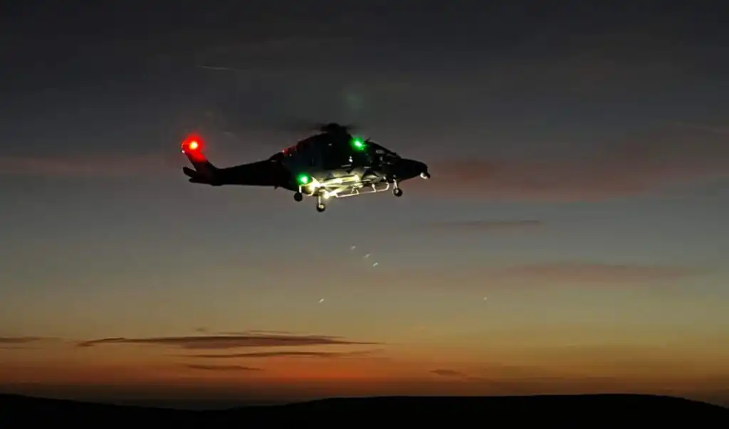 A KSS AW169 helicopter flying at night