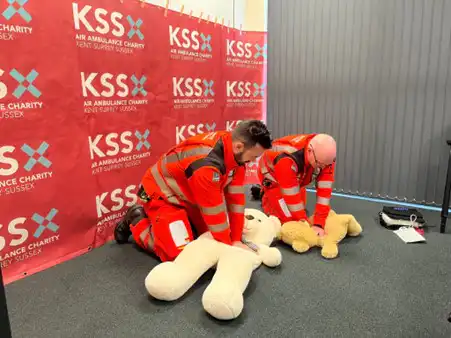 KSS paramedics demonstrating CPR on teddy bears