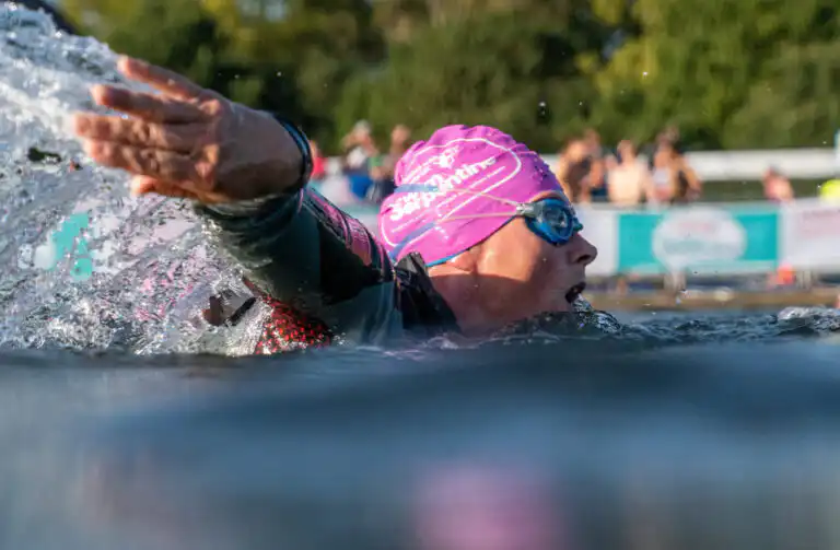 Person swimming with pink hat on