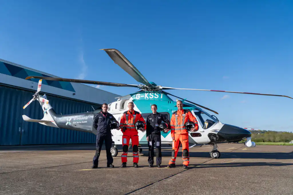 KSS crew standing in front of the helicopter.