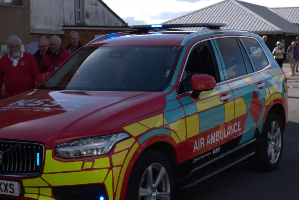 People looking at a rapid response vehicle