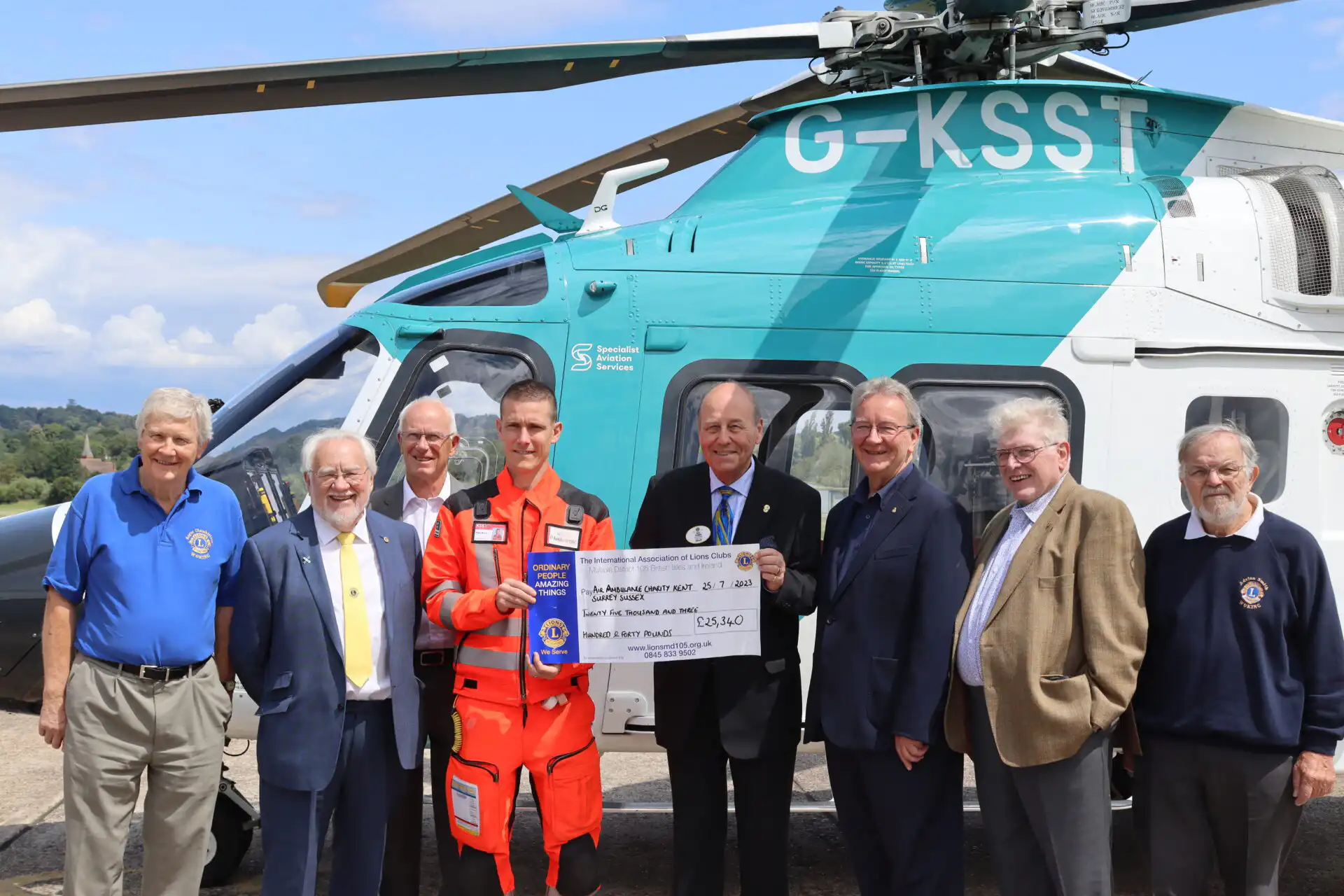 District Governor Paul Dedman and members of the steering group presenting a cheque to Team KSS