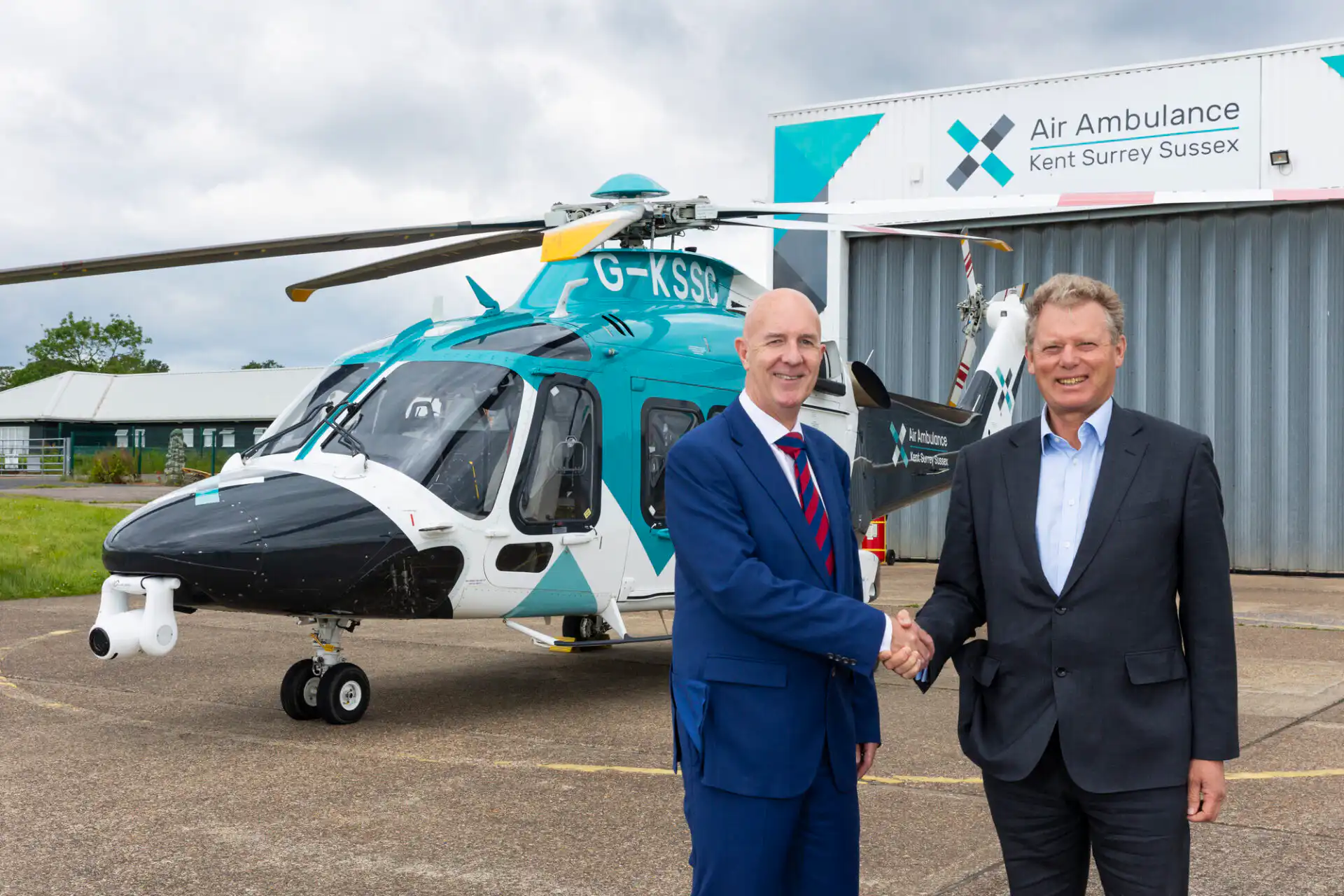 Jonathan Neame of Shepherd Neame with David Welch of KSS by one of the charity's helicopters