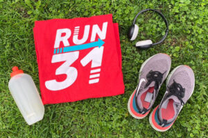 Run 31 T-shirt with trainers and a water bottle.
