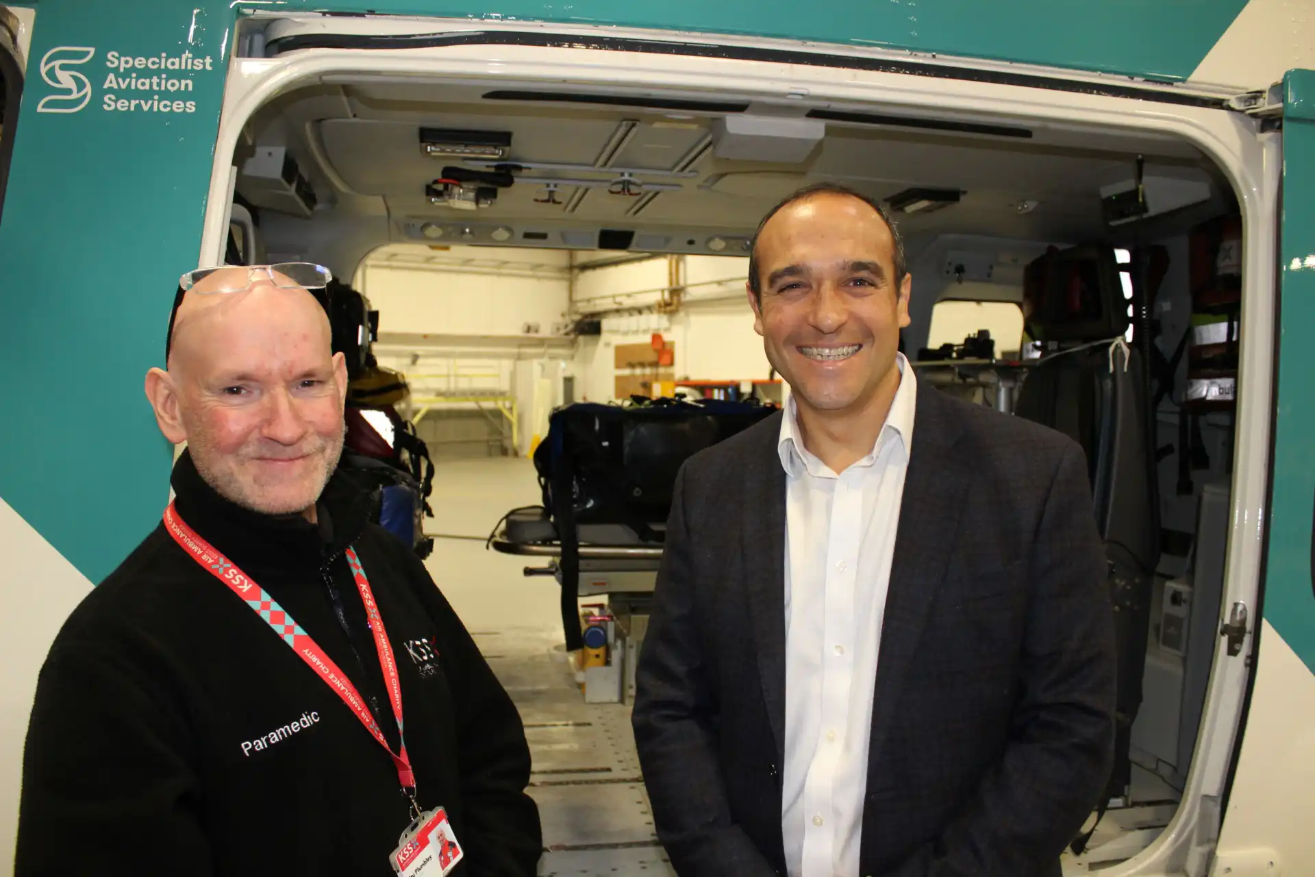 two men in front of camera looking at viewer