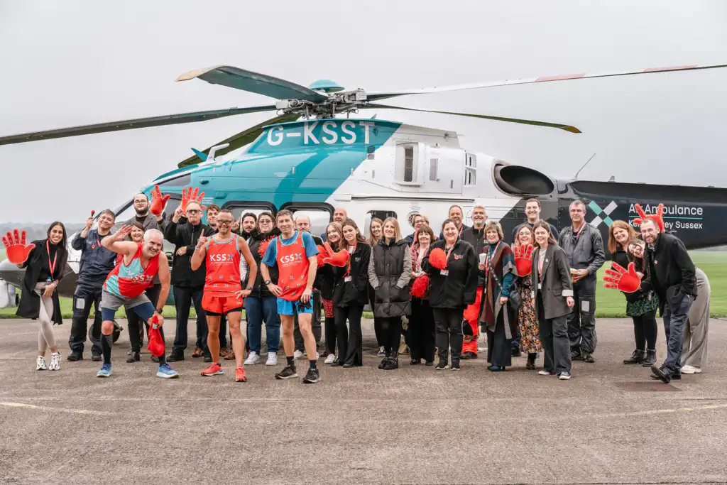 People standing in front of helicopter