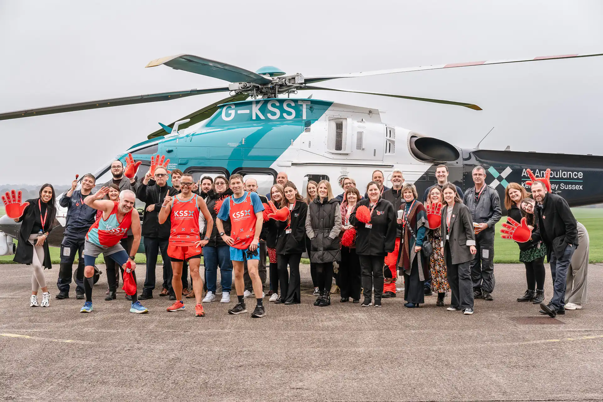 People standing in front of helicopter