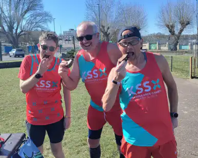 Three runners facing camera eating brownies