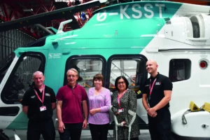 Carole and her husband Mick meeting KSS crew in front of the helicopter.